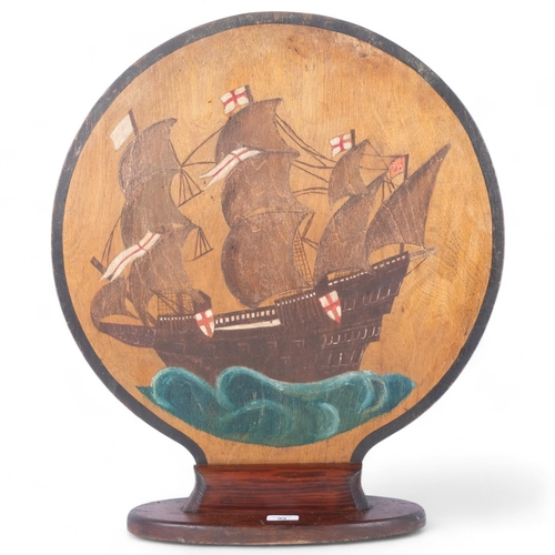 99 - An early  20th century fire screen with painted galleon decoration, H64cm