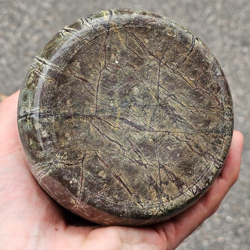 387 - Heavy 19th century serpentine marble doorstop, with brass ring handle, height 22cm