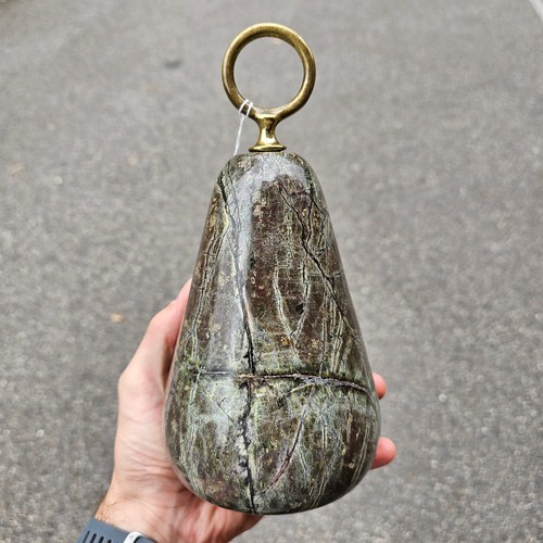 387 - Heavy 19th century serpentine marble doorstop, with brass ring handle, height 22cm