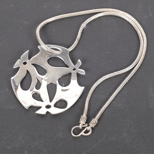 974 - A Continental sterling silver stylised pendant and chain