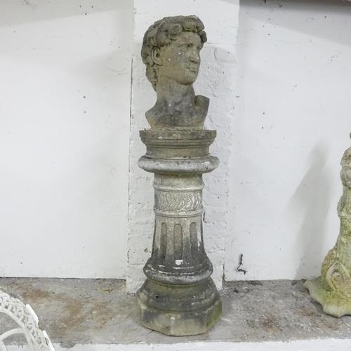 2814 - A weathered concrete bust, study of David, on associated fluted pedestal. Height overall 127cm.