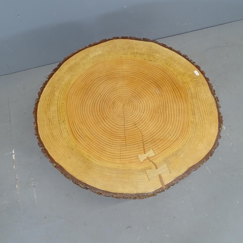 2903 - A live-edge tree slice coffee table on metal sled base. 76x46x72cm.