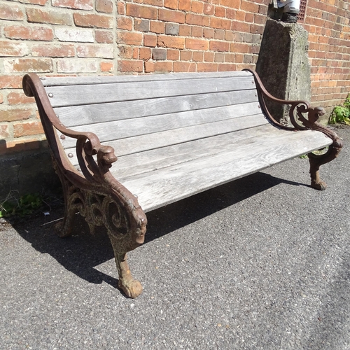 2945 - A teak slatted garden bench, with heavy Georgian cast iron ends. 158x73x80cm.