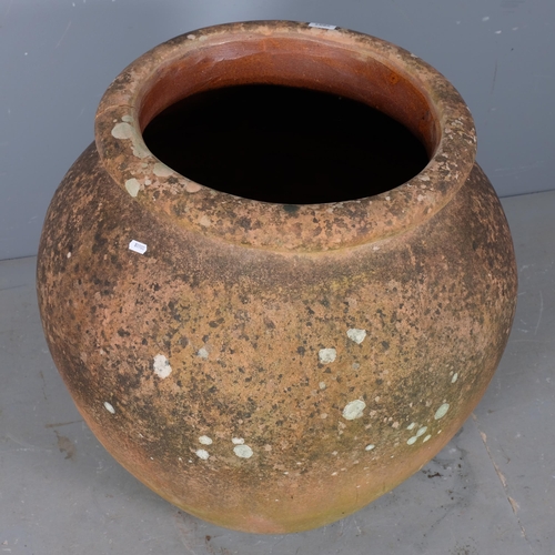 2803 - A large weathered terracotta garden urn. 70x76cm.