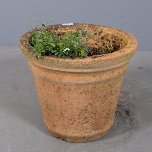 2806 - A weathered circular terracotta plant pot. 37x31cm.