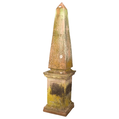 2813 - A weathered terracotta two-section obelisk on plinth. 38x162cm.