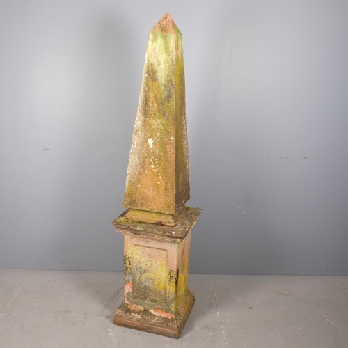 2813 - A weathered terracotta two-section obelisk on plinth. 38x162cm.