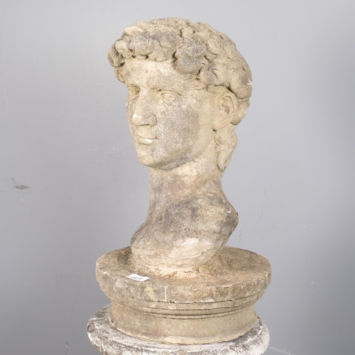 2814 - A weathered concrete bust, study of David, on associated fluted pedestal. Height overall 127cm.