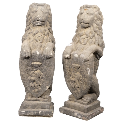 2817 - A pair of weathered concrete heraldric lion garden statues. Height 80cm.