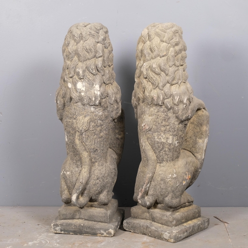 2817 - A pair of weathered concrete heraldric lion garden statues. Height 80cm.