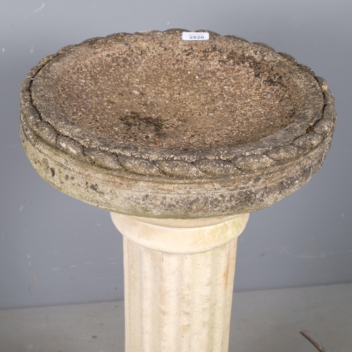 2820 - A weathered concrete two-section concrete birdbath. 41x77cm.