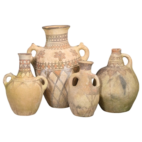 2826 - Four decorative terracotta olive oil jars with hand painted decoration. Tallest 55cm.