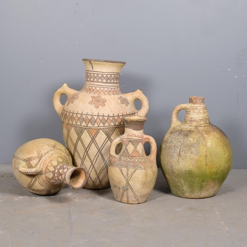 2826 - Four decorative terracotta olive oil jars with hand painted decoration. Tallest 55cm.