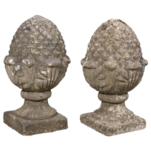 2832 - A pair of weathered concrete pineapple finials. 34x57cm.