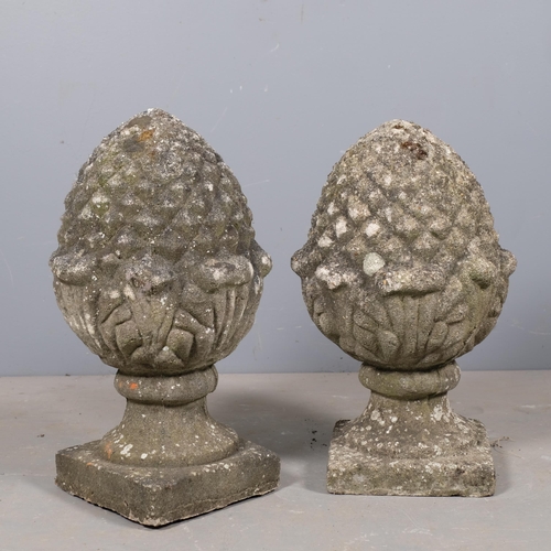 2832 - A pair of weathered concrete pineapple finials. 34x57cm.