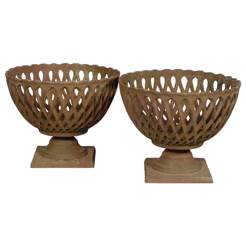 2834 - A pair of small cast iron basket planters, with pierced lattice decoration. 29x22cm.