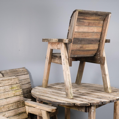 2844 - A weathered teak circular garden table, 117x79cm, with four matching armchairs.