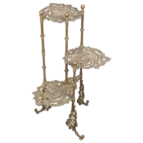 2857 - An Arts & Crafts style brass three-tier plant stand, with pierced and engraved stag decoration. Heig... 