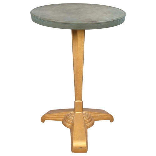 2858 - LOUIS VUITTON - A French Art Deco bistro table with circular Bakelite top on gilt painted cast iron ... 