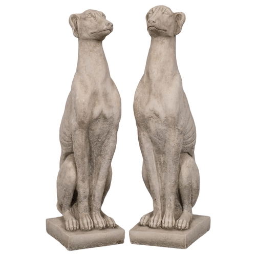 2872 - A pair of concrete whippet garden statues. Height 56cm.