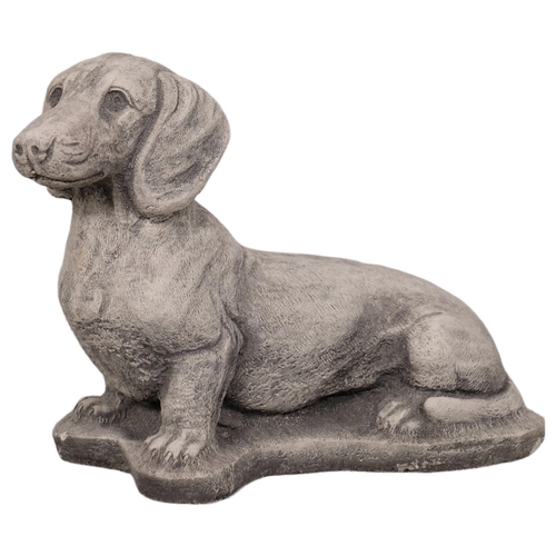 2873 - A concrete dachshund garden statue. 38x24cm.