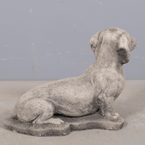 2873 - A concrete dachshund garden statue. 38x24cm.