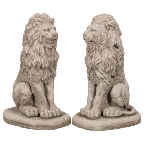 2874 - A pair of concrete garden lion statues. Height 42cm.