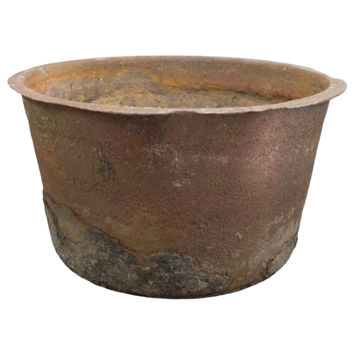 2881 - A large weathered cast iron planter with rounded base. 83x48cm.