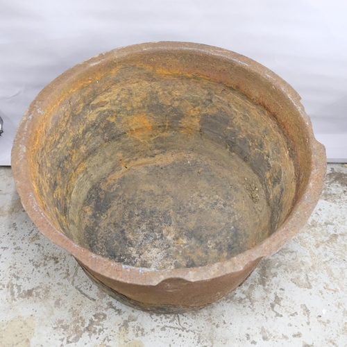 2881 - A large weathered cast iron planter with rounded base. 83x48cm.