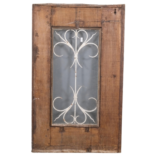 2884 - A painted pine door/window with wrought iron panel. 66x108cm.