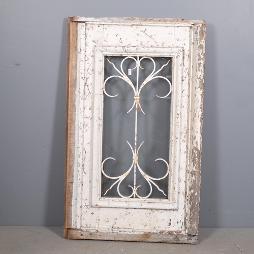 2884 - A painted pine door/window with wrought iron panel. 66x108cm.