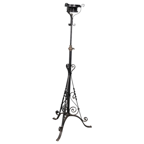 2885 - A painted wrought iron candle stand with telescopic base and ceramic bowl. Height 143cm.