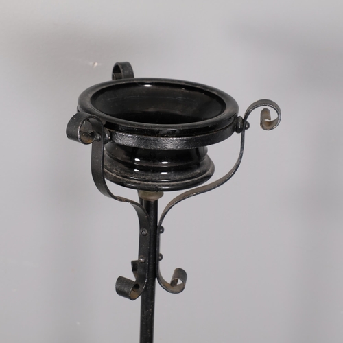 2885 - A painted wrought iron candle stand with telescopic base and ceramic bowl. Height 143cm.