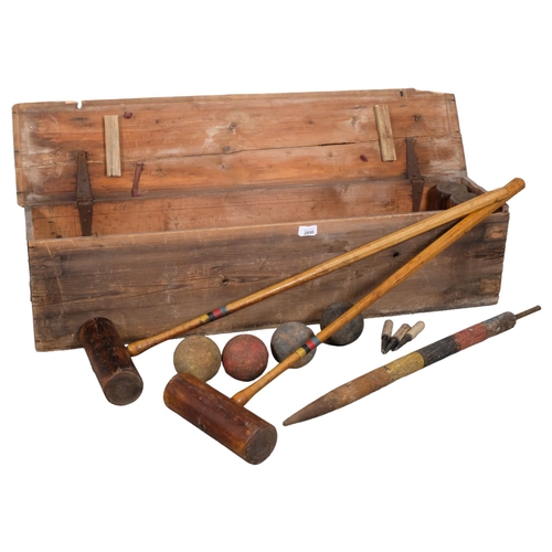 2890 - A vintage croquet set in pine case. 108x26x24cm.