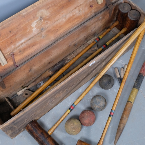 2890 - A vintage croquet set in pine case. 108x26x24cm.