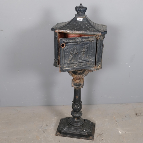 2892 - A painted cast iron letterbox. 42x113x29cm. Lacking lock.