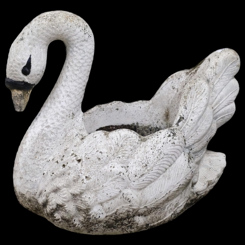 2902 - A painted cast reconstituted stone planter in the form of a swan. 58x50x44cm.