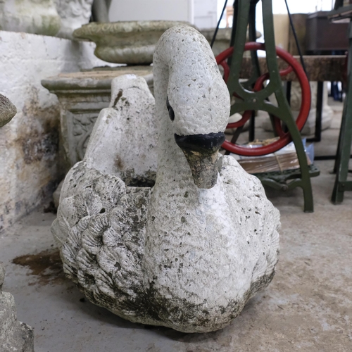 2902 - A painted cast reconstituted stone planter in the form of a swan. 58x50x44cm.