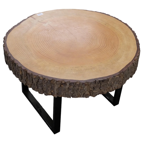 2903 - A live-edge tree slice coffee table on metal sled base. 76x46x72cm.