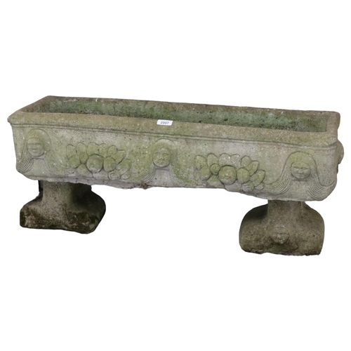 2907 - A weathered concrete rectangular garden planter, raised on two feet, with figural and floral decorat... 