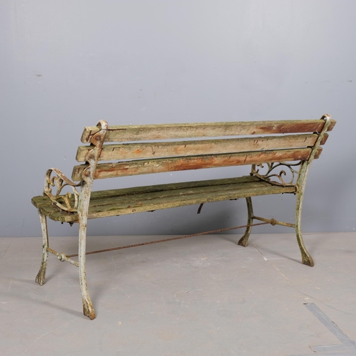 2921 - A teak slatted garden bench with painted cast iron ends. Overall 121x70x50cm.