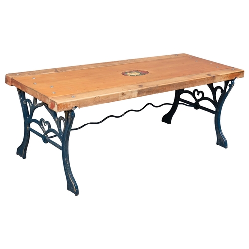 2942 - A pine garden bench / low table with cast iron base, with inset painted floral panel. 109x40x42cm.