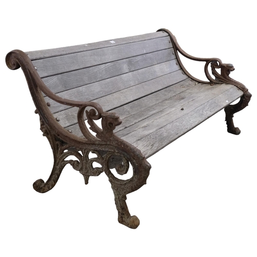 2945 - A teak slatted garden bench, with heavy Georgian cast iron ends. 158x73x80cm.