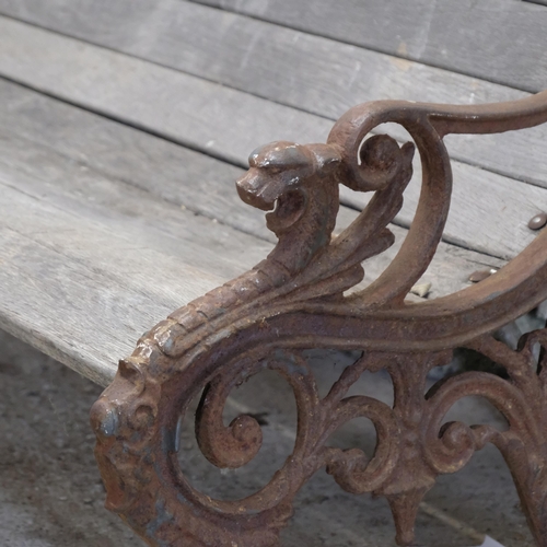 2945 - A teak slatted garden bench, with heavy Georgian cast iron ends. 158x73x80cm.