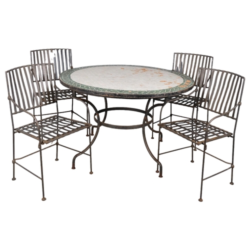 2946 - A circular tile-topped garden table on cast iron base, 120x76cm, and a set of four wrought-iron fold... 