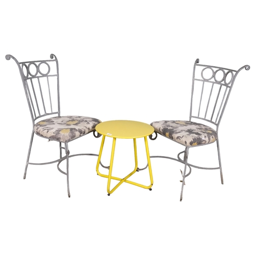 2968 - A pair of painted wrought metal and upholstered garden chairs, with a painted low table on tubular m... 