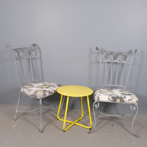 2968 - A pair of painted wrought metal and upholstered garden chairs, with a painted low table on tubular m... 