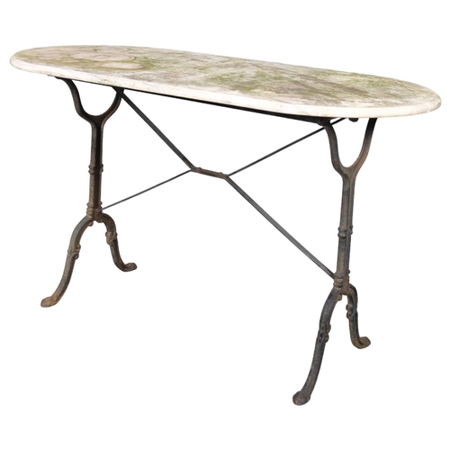 2970 - A weathered oval marble-topped garden table on cast iron frame. 120x72x60cm.