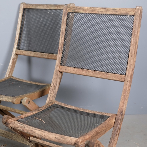 2983 - A set of four weathered teak folding garden chairs, with mesh panelled seats and backs.