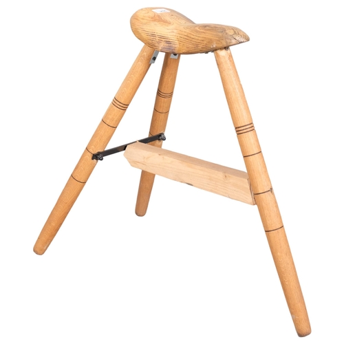 2984 - A handmade bicycle seat design stool on tripod base, by local artist Clive Fredriksson. Height 59cm.